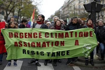 Defiant protesters stage climate march